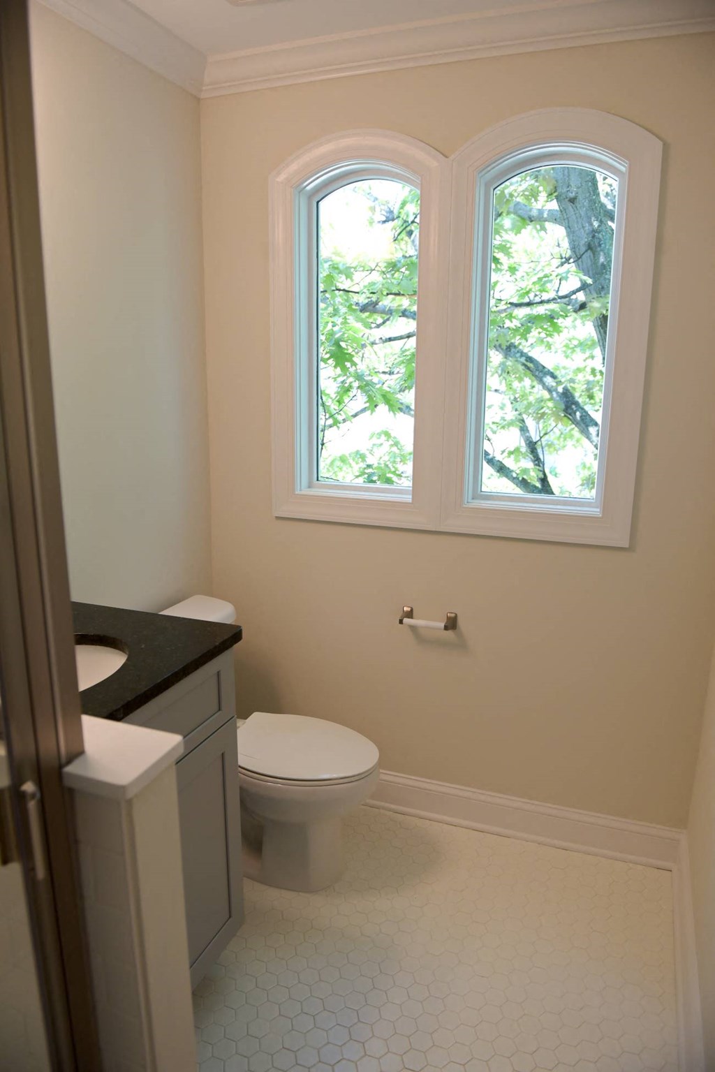 a small bathroom with a toilet and a window
