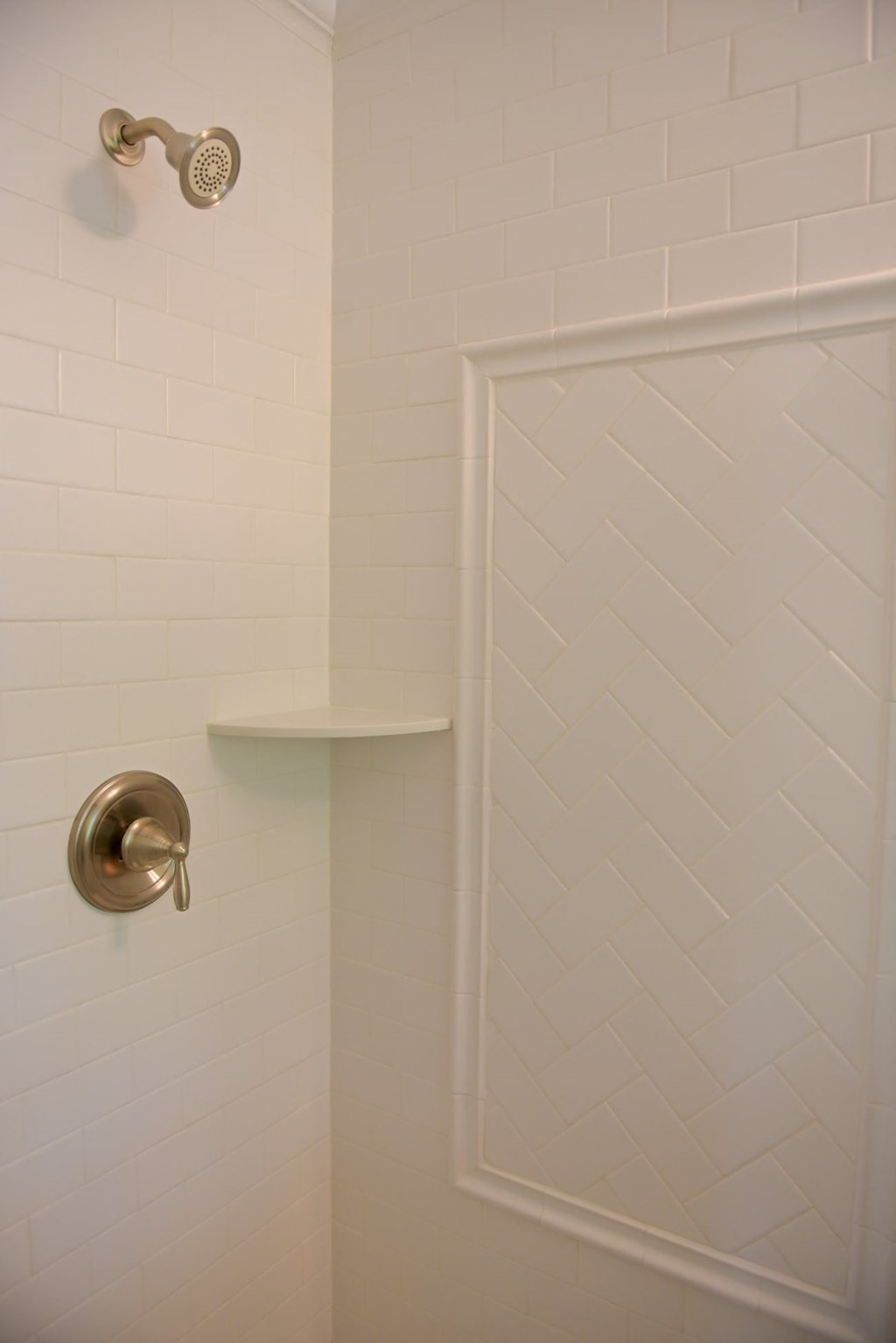 a white bathroom with a shower with a glass door