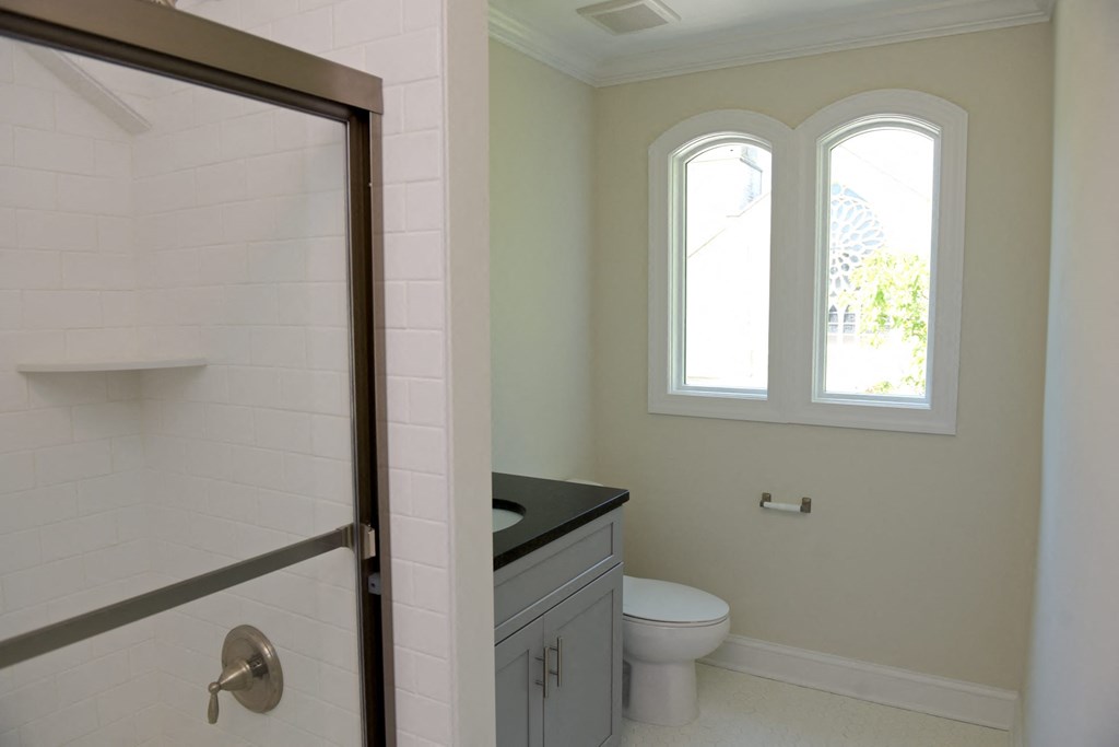 a bathroom with a toilet and a sink and a shower