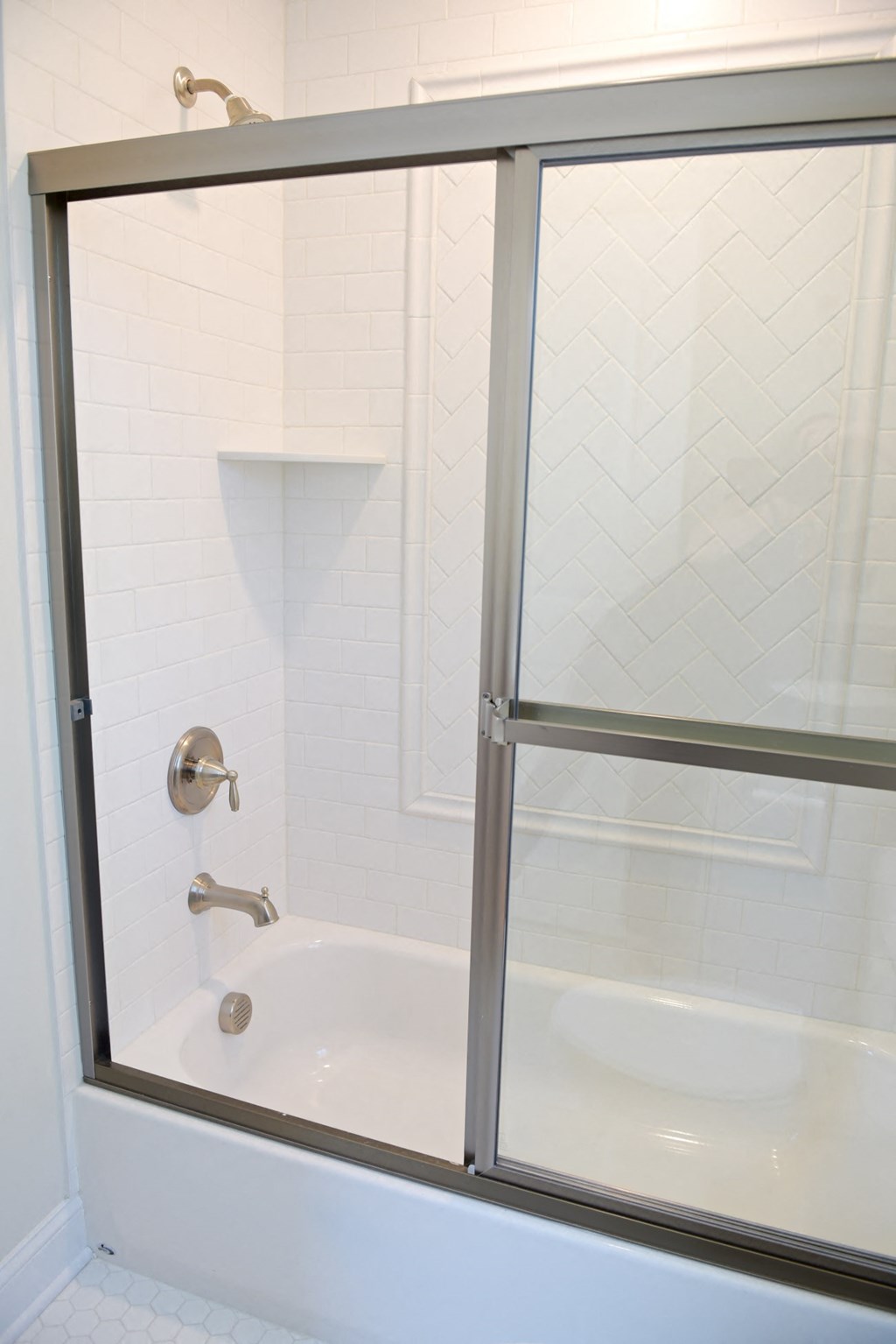 a white bathroom with a shower and a sink