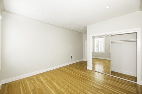 A room with wooden floors and white walls.