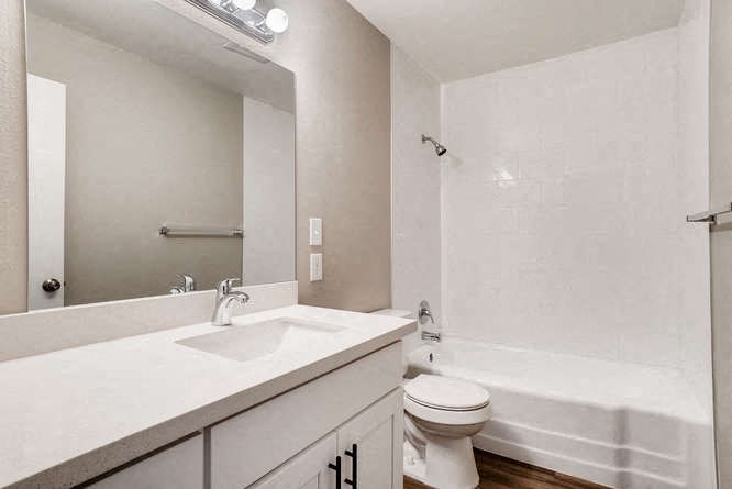 a bathroom with a sink toilet and a mirror