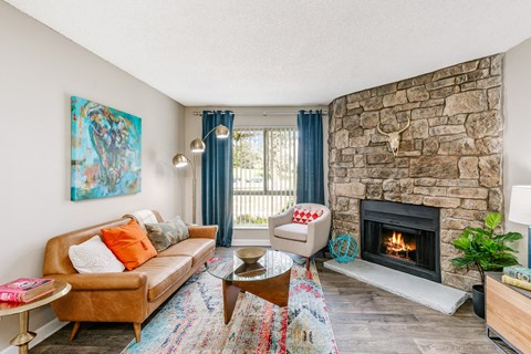a living room with a stone fireplace and a couch