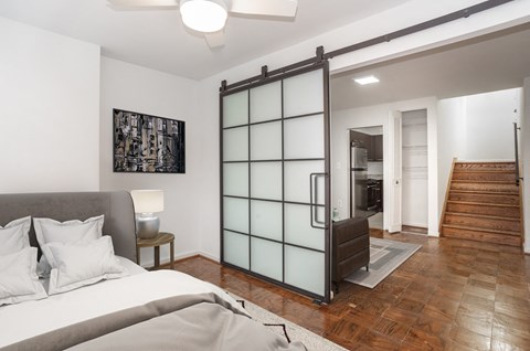 a bedroom with a bed and a sliding glass door