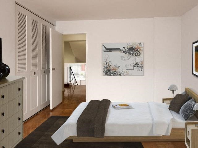 a bedroom with a bed and a painting on the wall