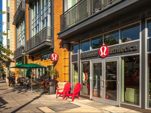 two red chairs sitting outside of a building