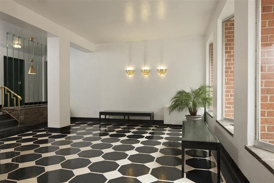 the lobby of a building with a black and white floor
