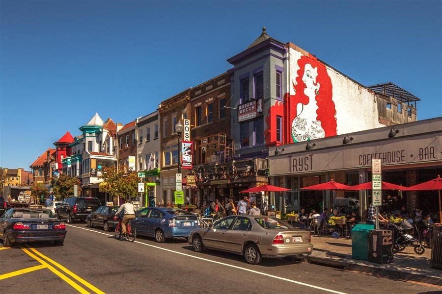 a busy city street filled with cars and buildings