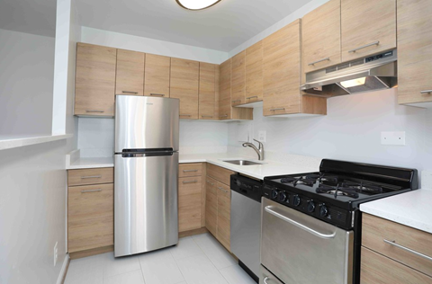 a kitchen with stainless steel appliances and wooden cabinets