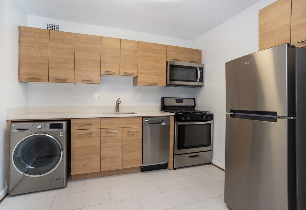 apartment kitchen featuring a dishwasher, refrigerator, and gas range stove
