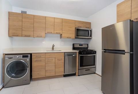 a kitchen with stainless steel appliances and wooden cabinets