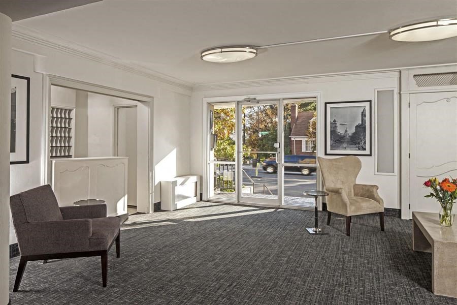 a living room with chairs and a table