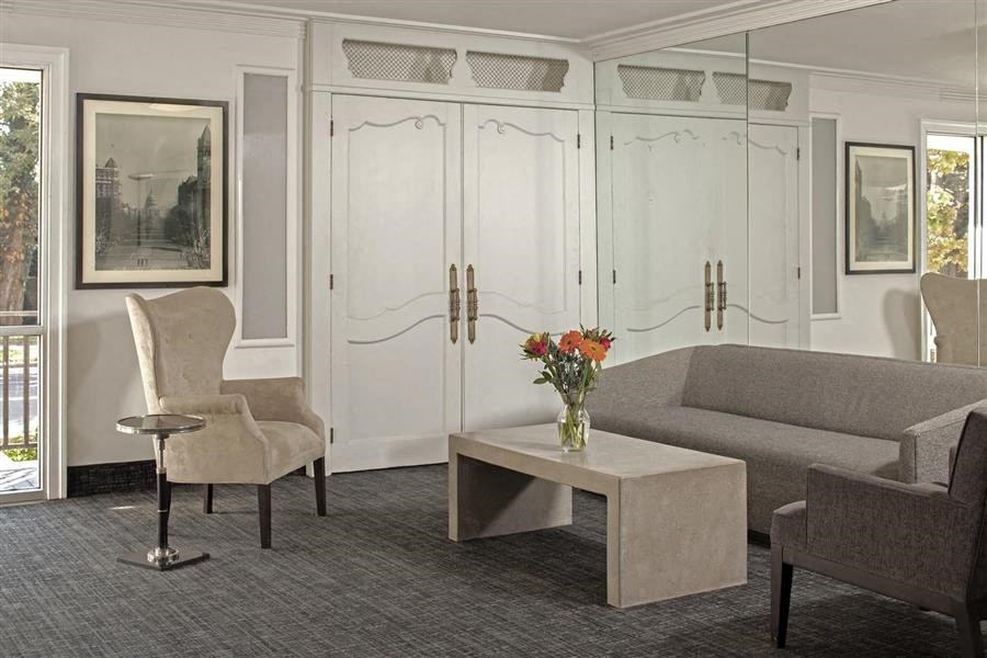 a living room with a couch and chairs and a table