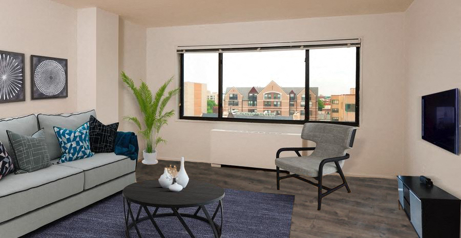 a living room with a couch and a chair and a window