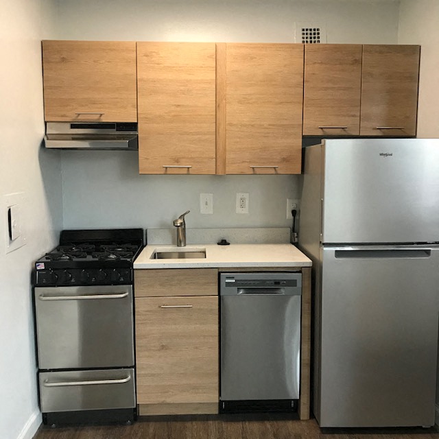 a kitchen with stainless steel appliances and wooden cabinets