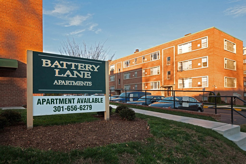 a battery lane apartments sign in front of a building