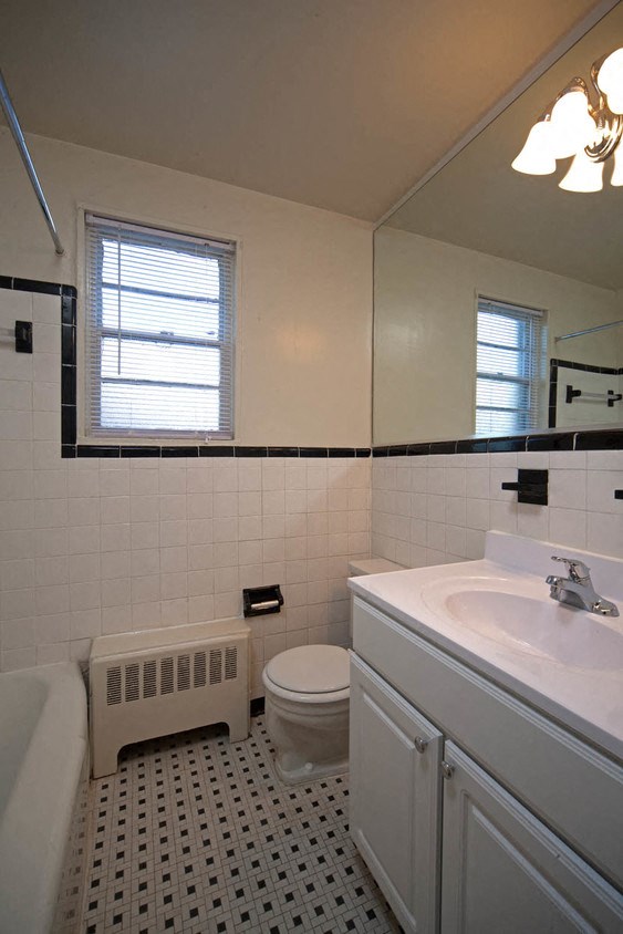 a bathroom with a sink toilet and a bath tub