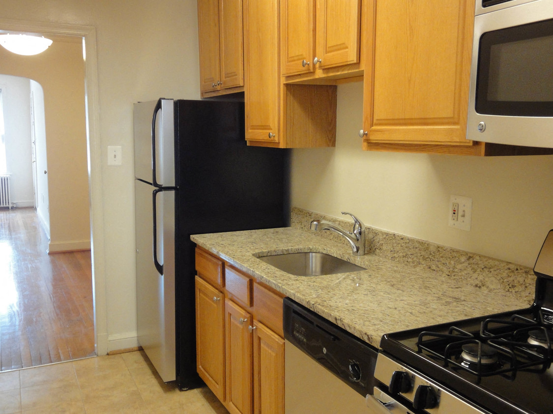 a kitchen with a sink and a refrigerator