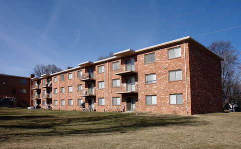 a brick apartment building on the side of a hill