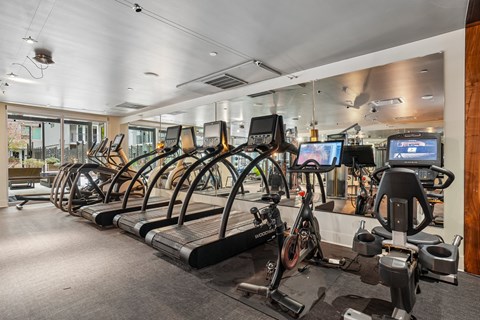 A gym with treadmills and exercise bikes.