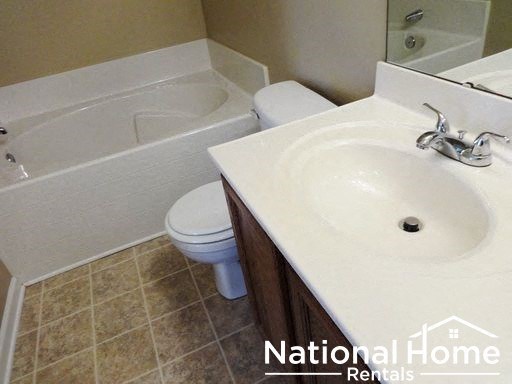a bathroom with a sink toilet and a bath tub