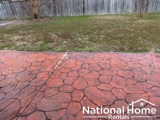 a driveway that has been repaired with red stones