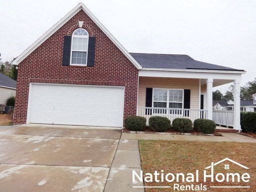 a red brick house with a white garage door