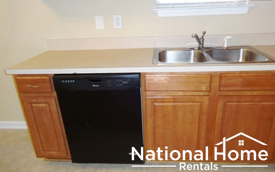A kitchen with a sink and a dishwasher.