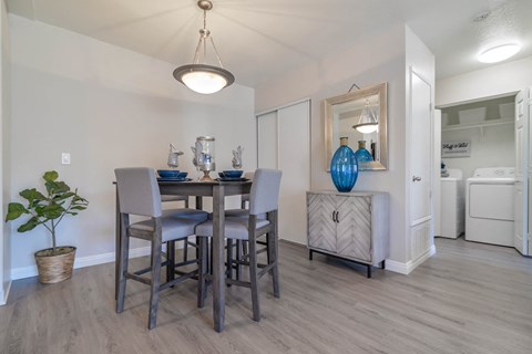 A dining room with a table and chairs.