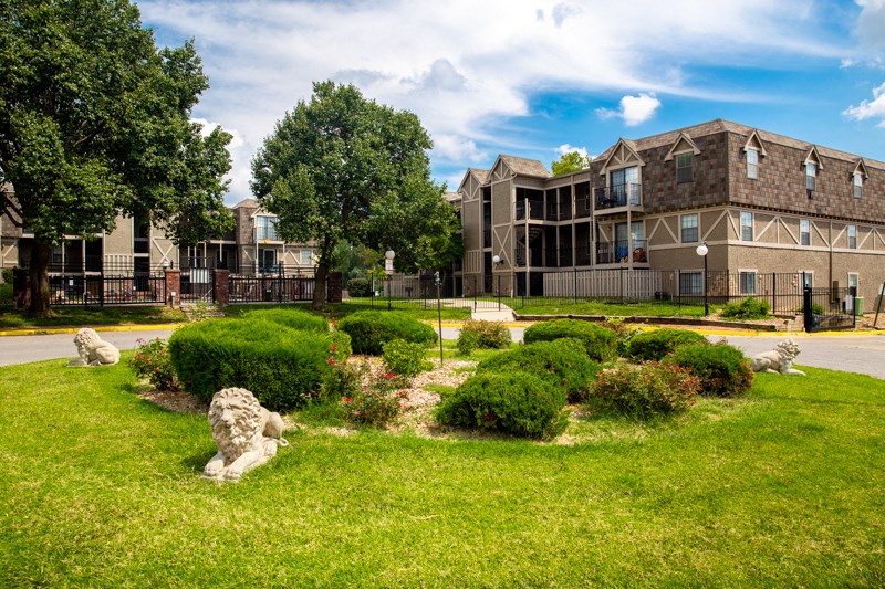 a view of a building with a garden in front of it