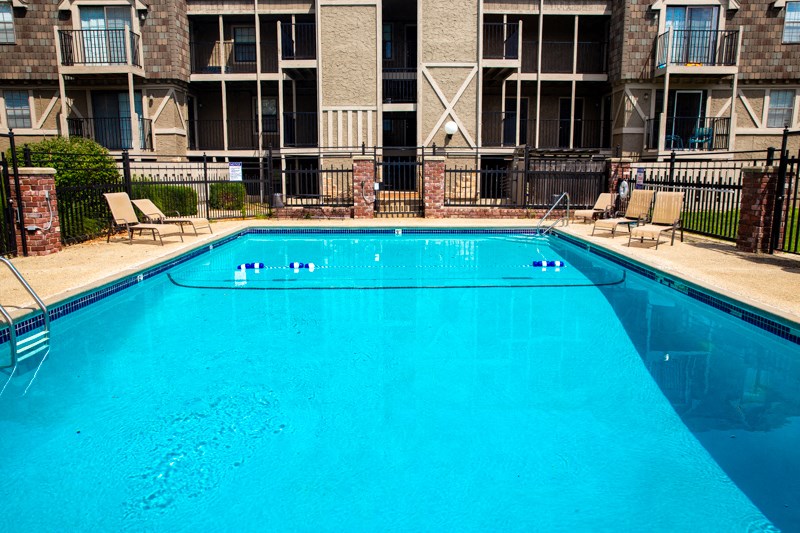 a large pool in front of an apartment building