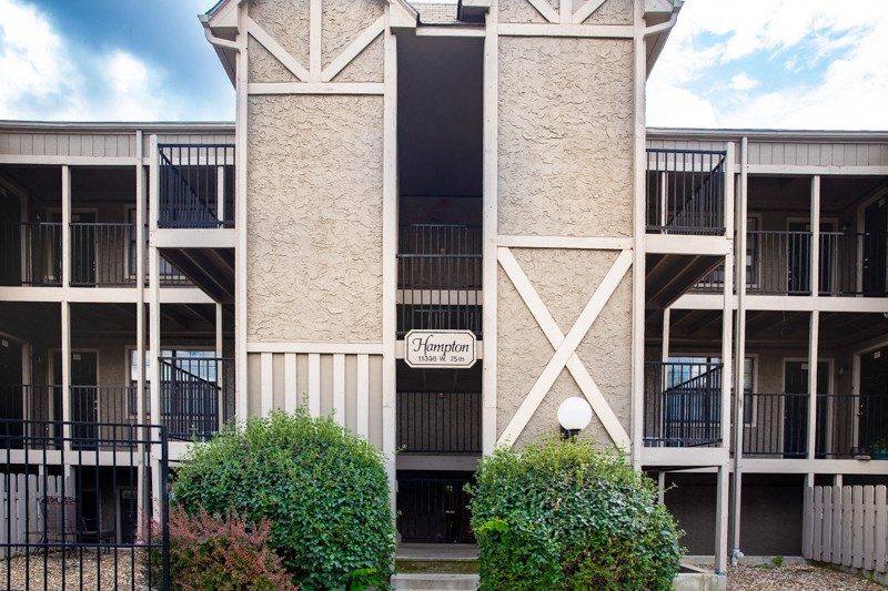 an exterior view of a building with a sign on the side of it