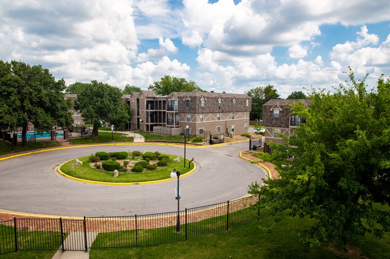 an aerial view of an apartment complex with a roundabout in front of a building