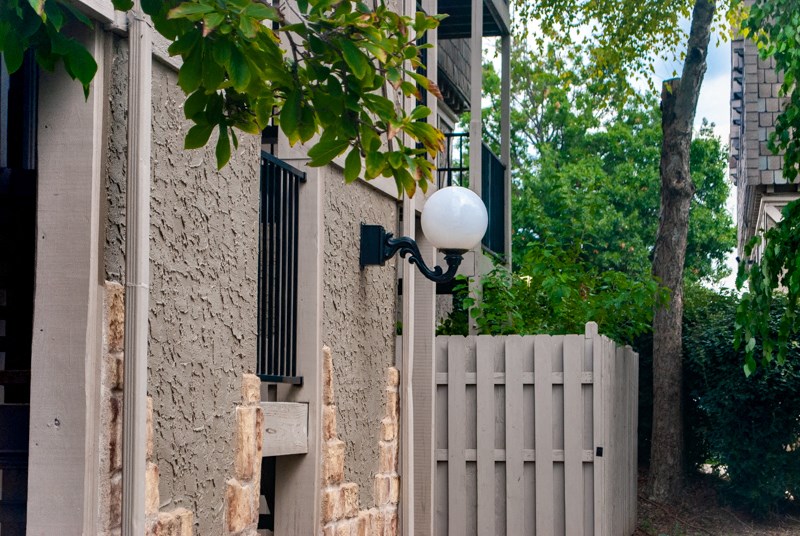 an old building with a fence and a street light