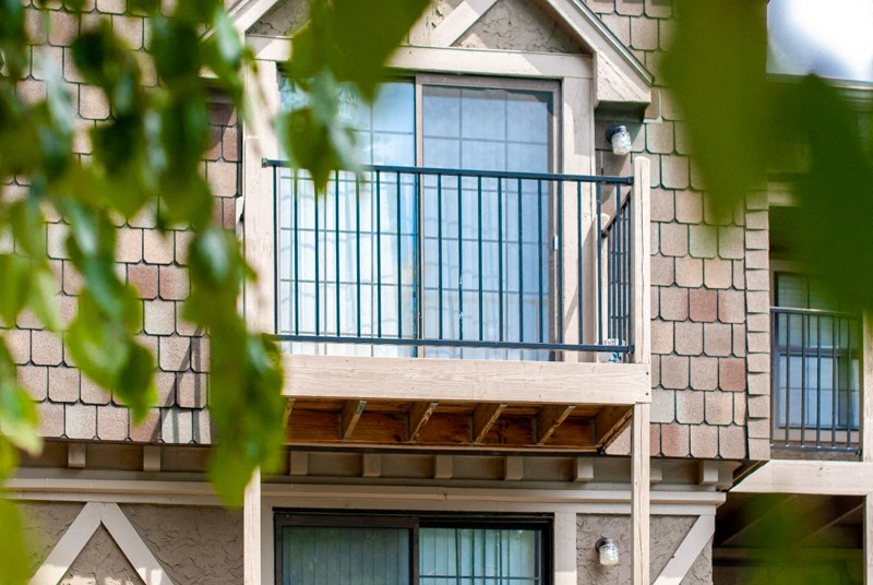an apartment building with a balcony and a balcony guard rail