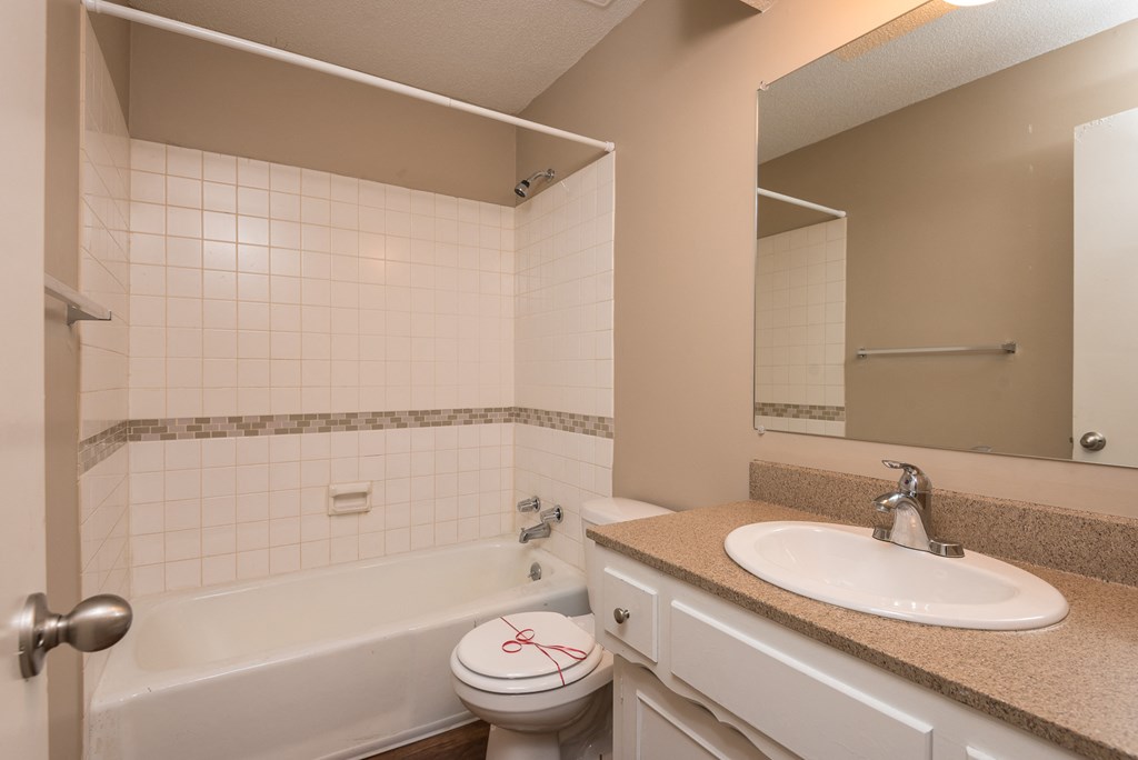 an empty bathroom with a sink toilet and bath tub