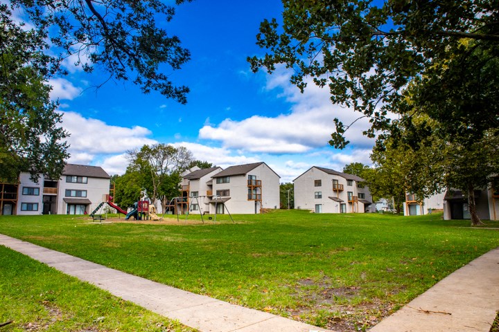 a group of houses in a park with a playground