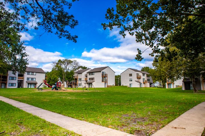 a group of houses in a park with a playground