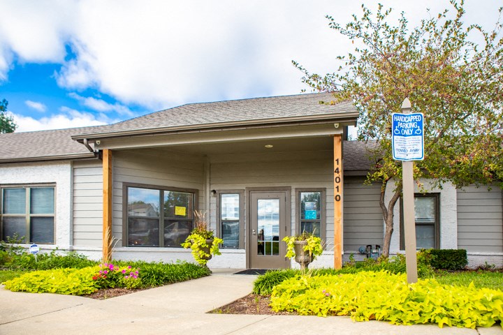 the front of a building with a blue and white street sign in front of it