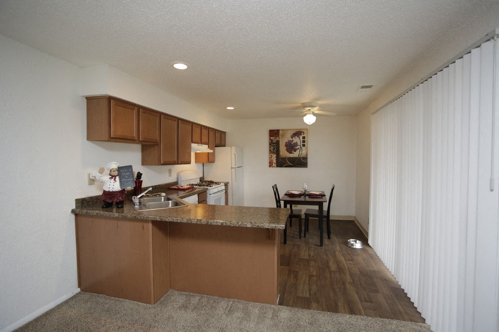a view of a kitchen and dining area in a apartment