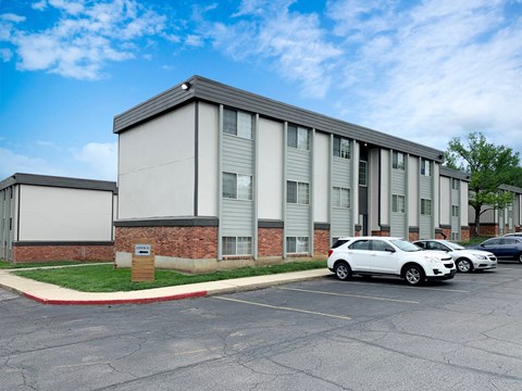 a large building with cars parked in front of it