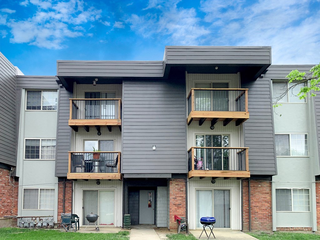 a row of apartments with balconies and a blue sky