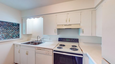 a kitchen with white cabinets and black appliances and a sink