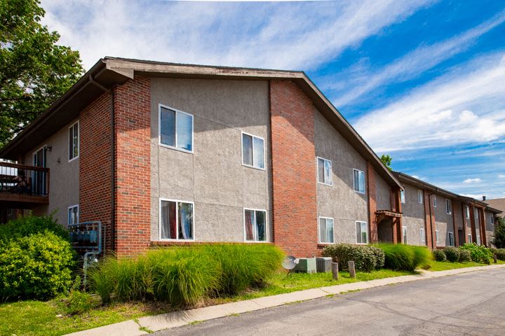 a brick apartment building with a street in front of it