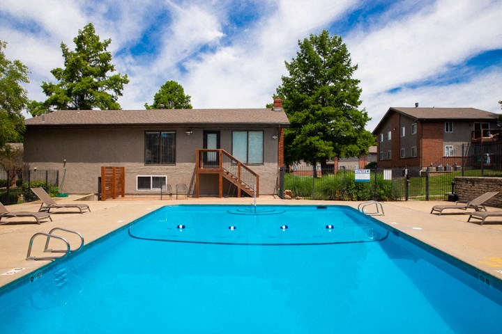 a swimming pool with a house in the background