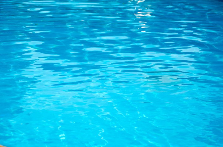the water in the pool is clear and blue