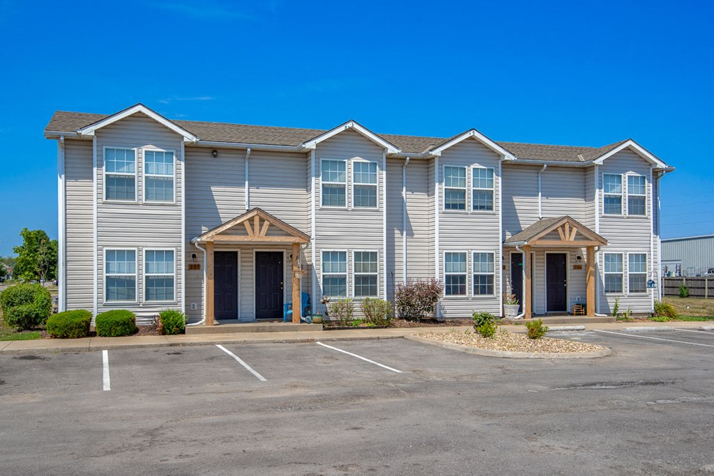 the exterior of a building with a parking lot
