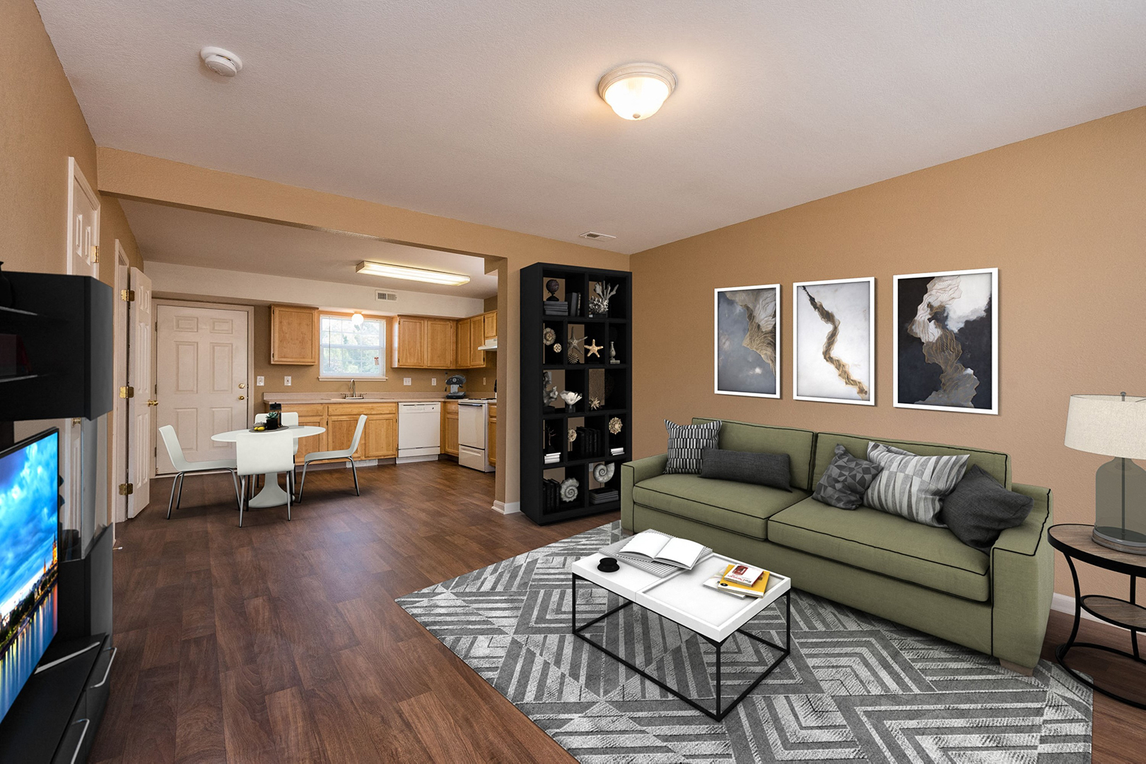 a living room and kitchen with a couch and a table