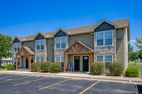 the exterior of a building with a parking lot
