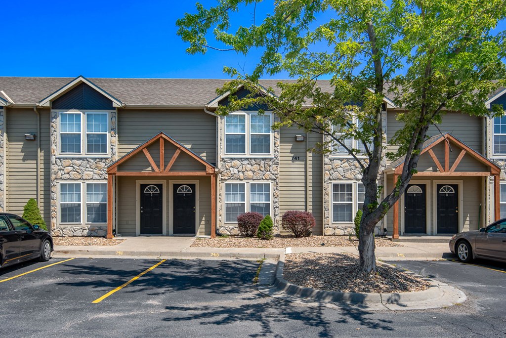 the exterior of a building with a tree in front of it